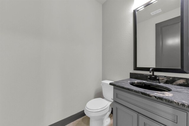 16179 Sheridan River Trl, Conroe, TX 77302 - bathroom with toilet, vanity, and baseboards