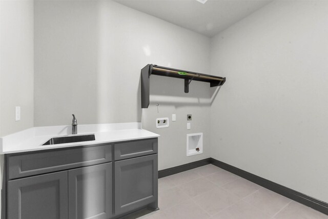 16179 Sheridan River Trl, Conroe, TX 77302 - washroom featuring hookup for an electric dryer, hookup for a washing machine, cabinet space, baseboards, and light tile patterned floors