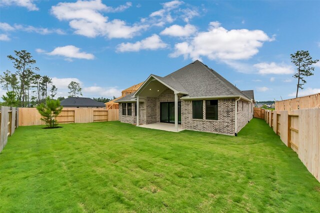 16179 Sheridan River Trl, Conroe, TX 77302 - back of house featuring brick siding, a shingled roof, and a patio area
