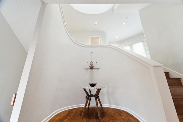 stairway with hardwood / wood-style floors