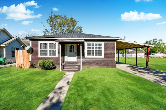 view of front facade with a front lawn and a carport