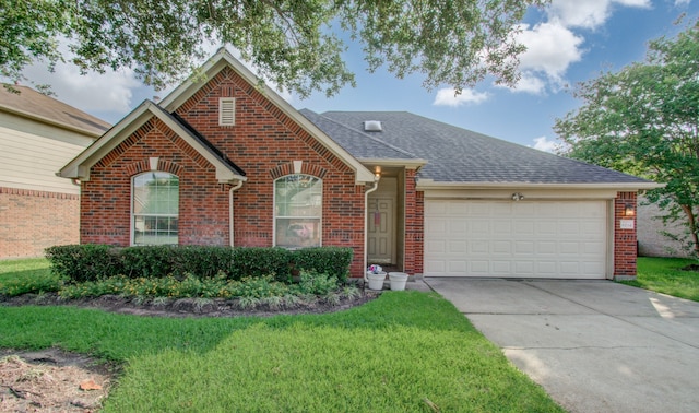 view of front of house with a front lawn and a garage