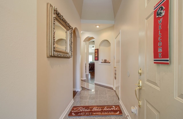 corridor with vaulted ceiling