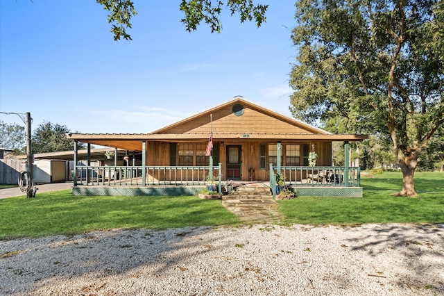 farmhouse with covered porch and a front yard