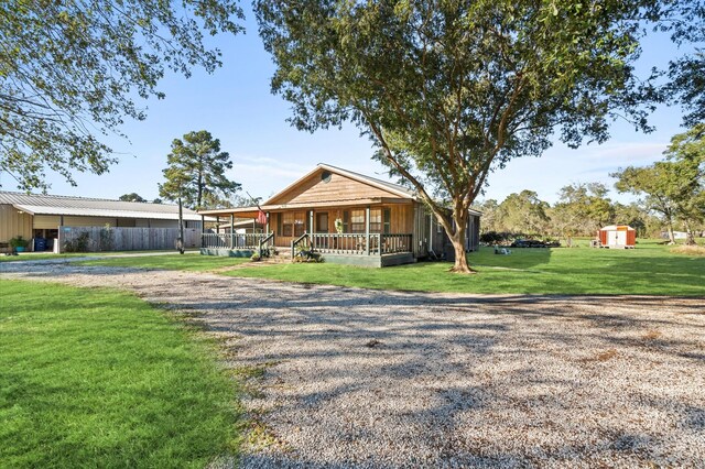 view of front of house featuring covered porch and a front yard