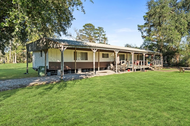 rear view of property featuring a yard