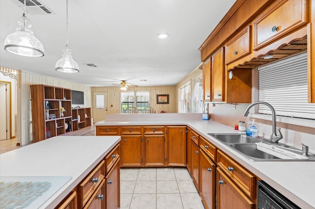 kitchen featuring dishwasher, sink, hanging light fixtures, ceiling fan, and light tile patterned floors