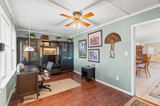 office featuring crown molding, ceiling fan, wood-type flooring, and a textured ceiling