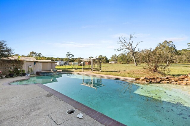 view of pool with a lawn, an in ground hot tub, and a patio