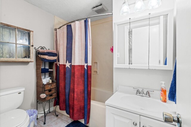 full bathroom with vanity, a textured ceiling, shower / bath combo with shower curtain, tile patterned flooring, and toilet