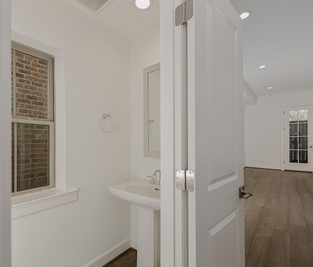 bathroom featuring hardwood / wood-style floors and ornamental molding