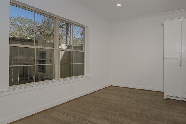 spare room with hardwood / wood-style flooring and crown molding