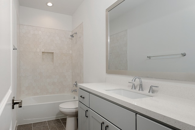 full bathroom featuring tile patterned flooring, vanity, toilet, and tiled shower / bath