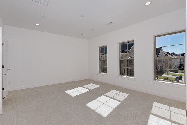 unfurnished room with light colored carpet