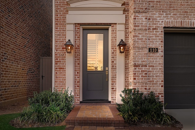 doorway to property with a garage