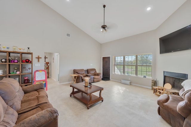 carpeted living room featuring ceiling fan and high vaulted ceiling