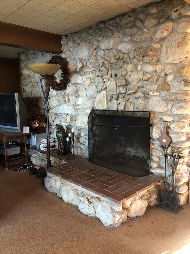 interior details with carpet floors and a fireplace