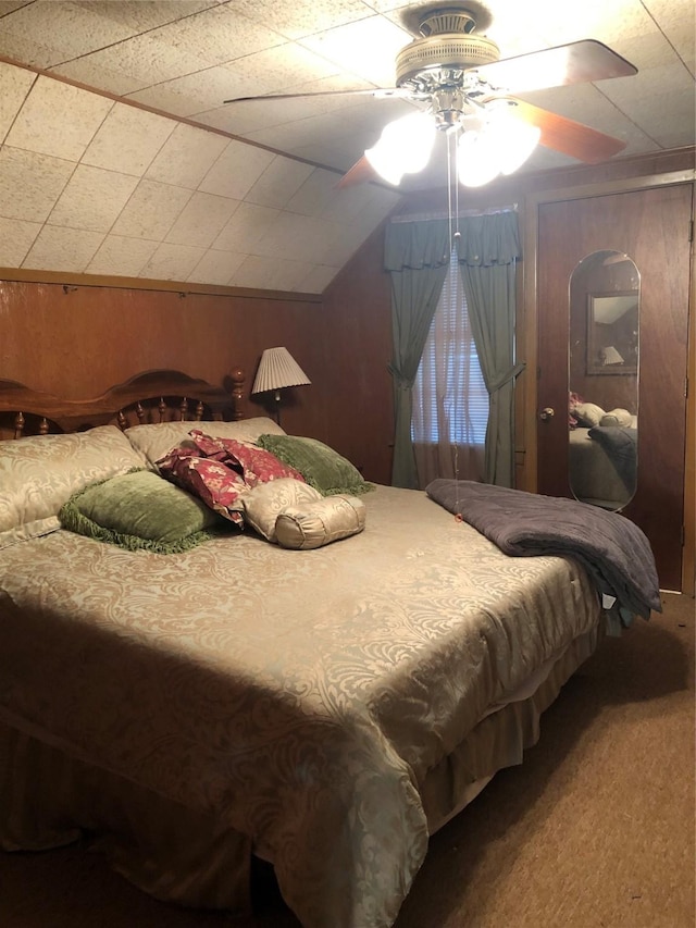1544 E Taylor Lake Cir, Livingston, TX 77351 - bedroom with carpet, wood walls, a ceiling fan, and vaulted ceiling