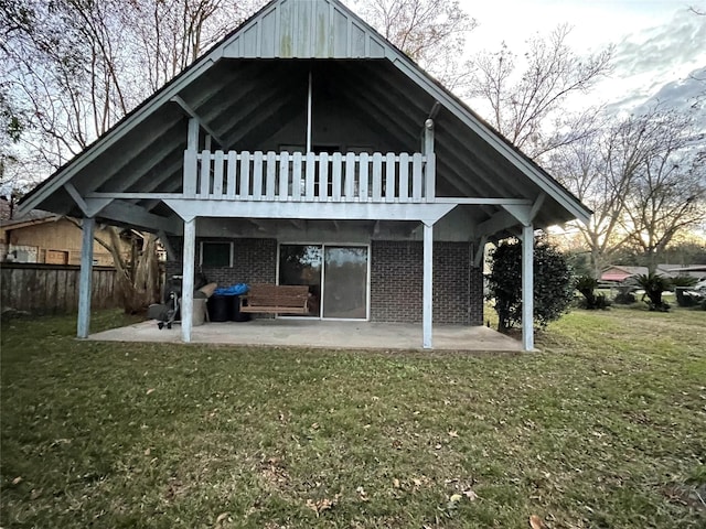 rear view of property with a lawn and a patio