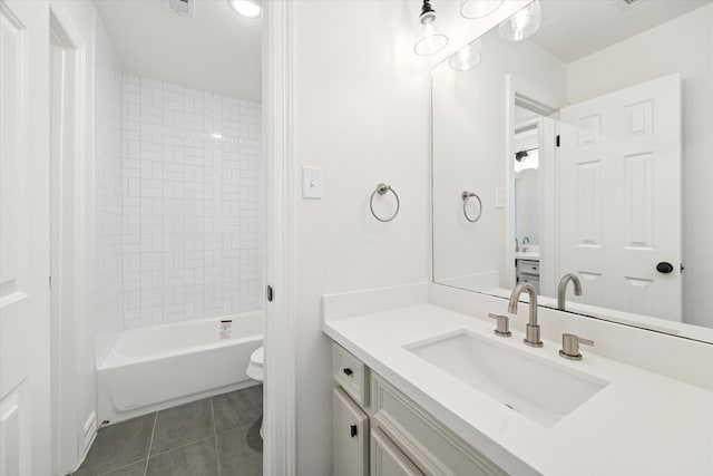 full bathroom with tile patterned floors, vanity, toilet, and tiled shower / bath combo