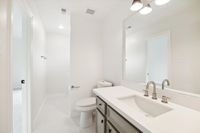 bathroom featuring tile patterned floors, vanity, and toilet