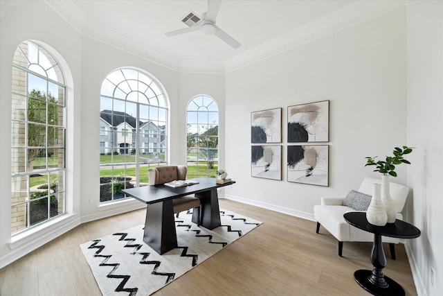 office area with a wealth of natural light, ceiling fan, and light wood-type flooring