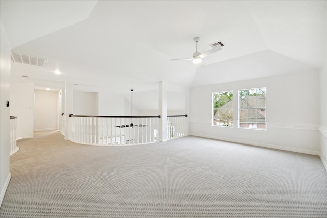 unfurnished room featuring ceiling fan, light carpet, and vaulted ceiling