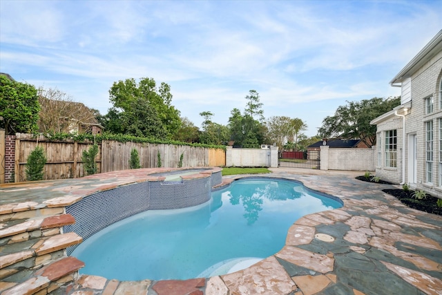 view of pool with an in ground hot tub and a patio