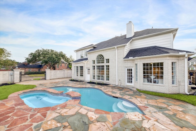 view of pool with a patio area and an in ground hot tub