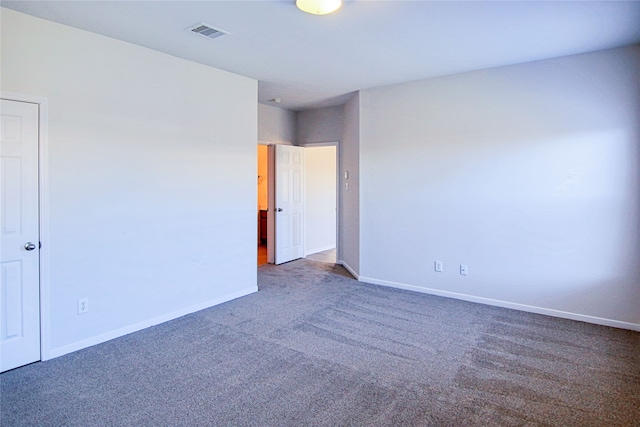 interior space featuring carpet floors, visible vents, and baseboards