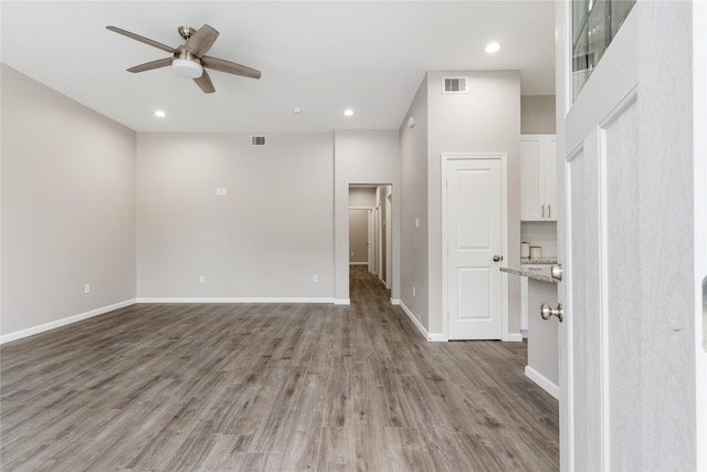 1319 E 35th St, Houston, TX 77022 - empty room with a ceiling fan, light wood-type flooring, baseboards, and recessed lighting