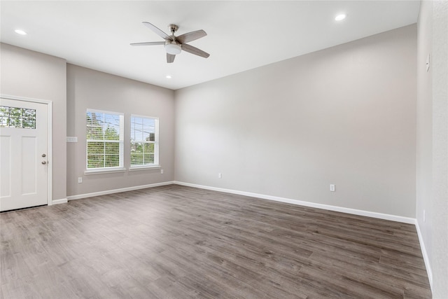 interior space featuring ceiling fan, baseboards, wood finished floors, and recessed lighting