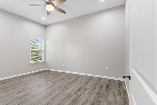 spare room with a ceiling fan, recessed lighting, baseboards, and wood finished floors