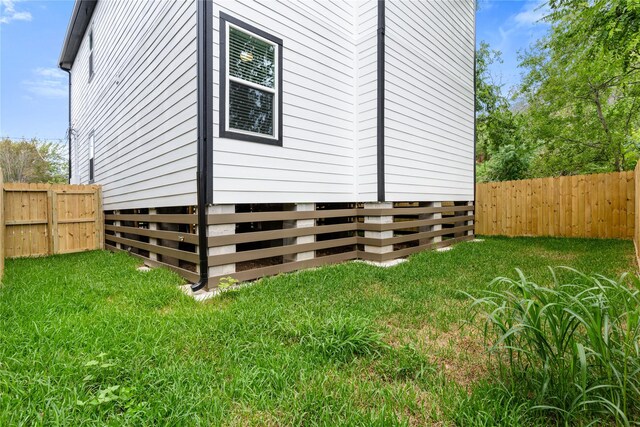 view of home's exterior with a yard and a fenced backyard