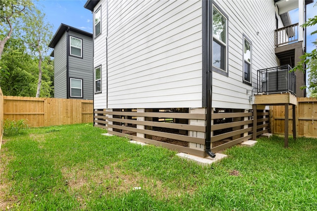 view of home's exterior featuring a yard and fence