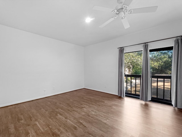 unfurnished room with ceiling fan and hardwood / wood-style flooring