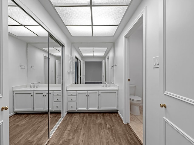 bathroom featuring hardwood / wood-style floors, vanity, and toilet