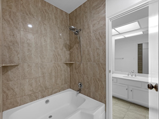 bathroom with tile patterned floors, vanity, and tiled shower / bath combo