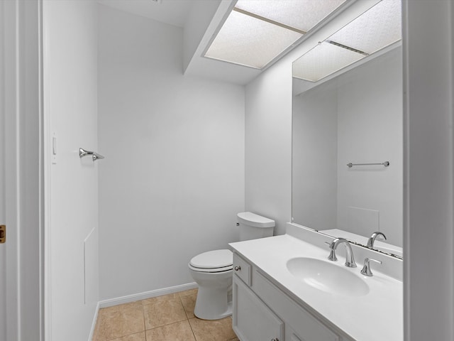 bathroom featuring tile patterned flooring, vanity, and toilet