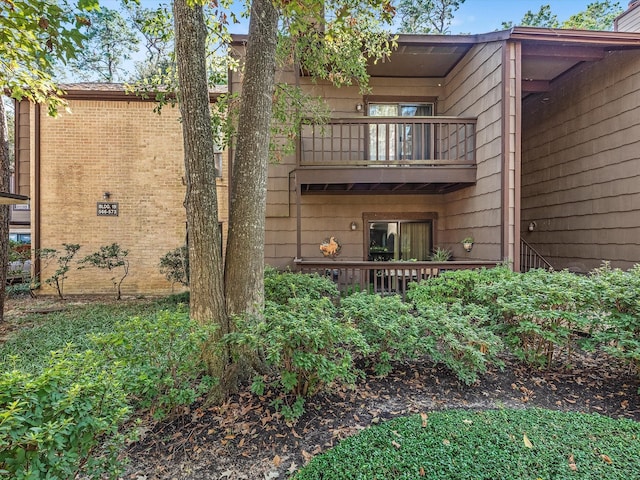 rear view of property featuring a balcony