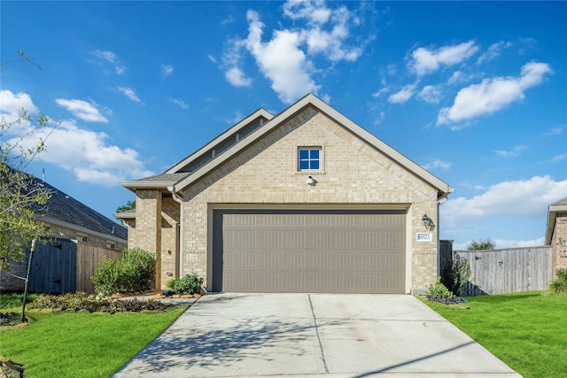 view of front of property featuring a garage and a front lawn