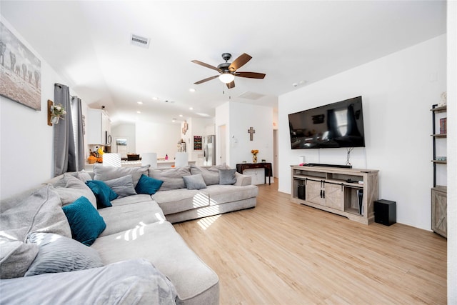 living room with ceiling fan and light hardwood / wood-style floors