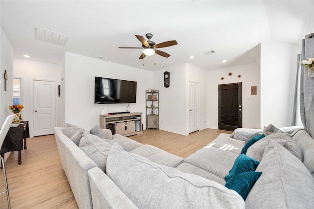 living room with light wood-type flooring and ceiling fan