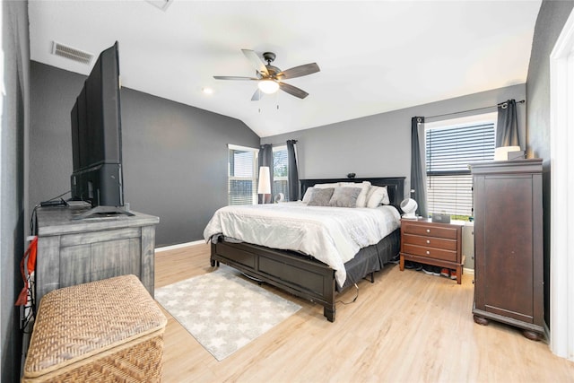 bedroom featuring light hardwood / wood-style flooring, ceiling fan, and lofted ceiling