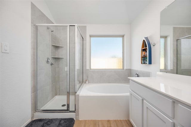 bathroom with vanity, plus walk in shower, and wood-type flooring