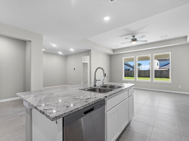 kitchen with white cabinetry, sink, ceiling fan, stainless steel dishwasher, and a kitchen island with sink