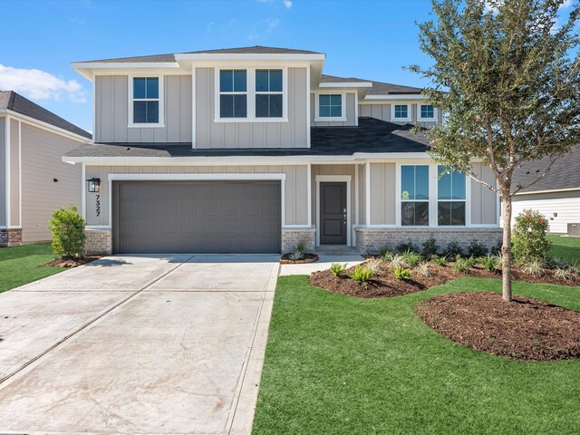 view of front facade with a garage and a front lawn