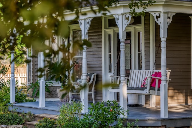 view of side of home featuring covered porch