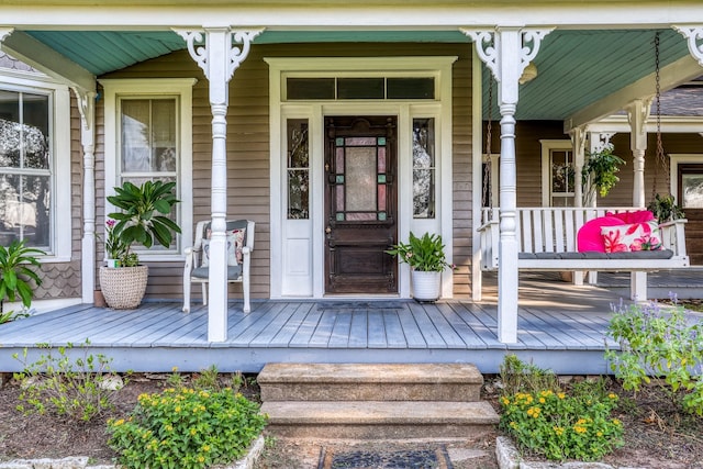 view of exterior entry with covered porch