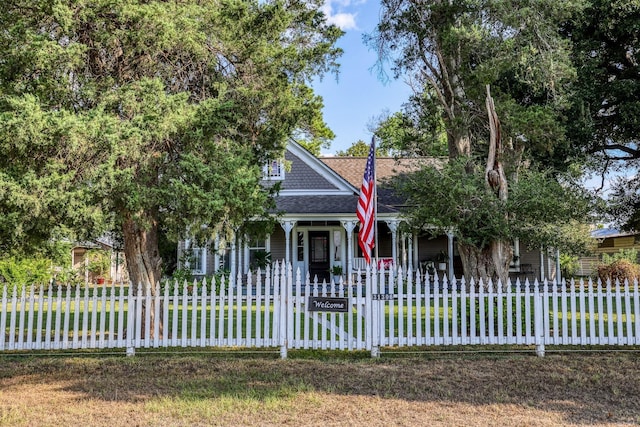 31306 Waller Tomball Rd, Waller, TX 77484 - view of front facade featuring covered porch, a shingled roof, and a fenced front yard